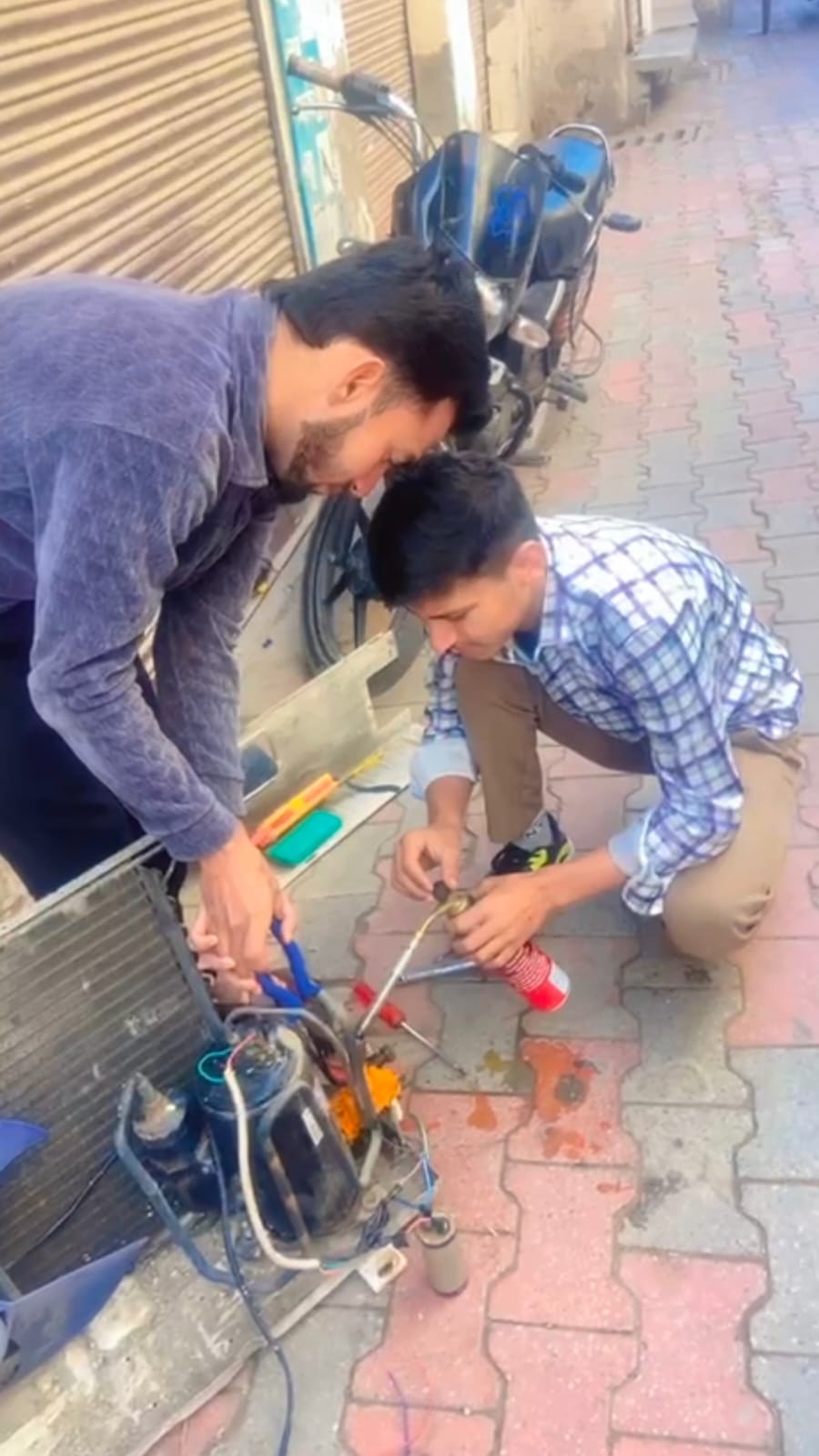 Split AC repair service by professional technician fixing air conditioner unit.