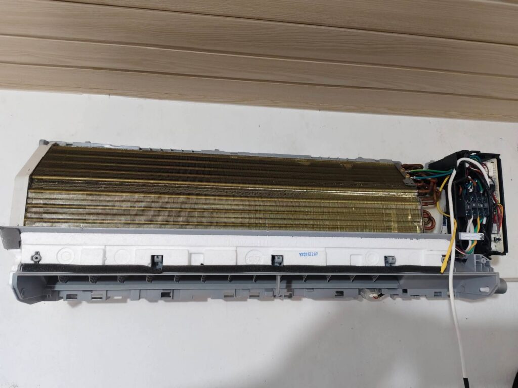 Professional AC repair technician servicing a split air conditioner in Panchkula with tools for AC maintenance, repair, and cooling restoration.